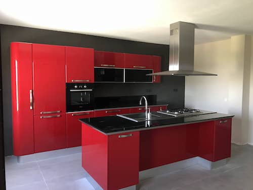 Large kitchen, designed specifically for high end villa with bright red finish