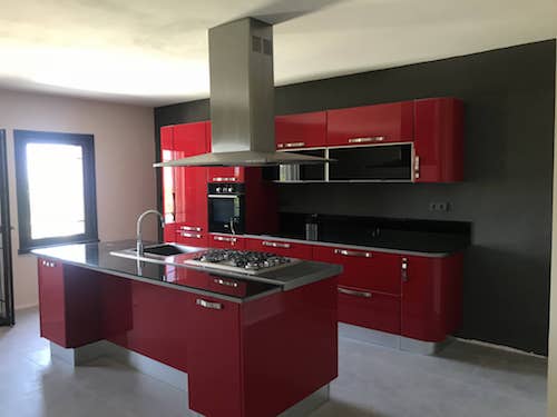 Large kitchen, designed specifically for high end villa with bright red finish 