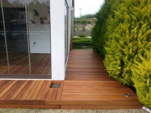 Garden decking made from Iroko wood, finished with teak oil. Designed and made by Ugur Bolat