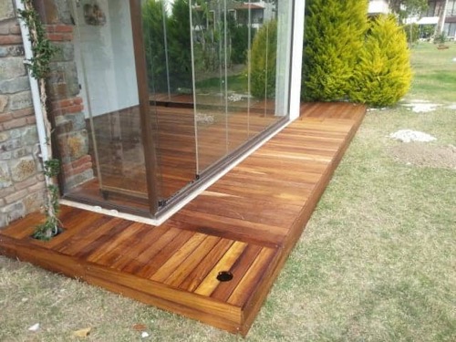 Garden decking made from Iroko wood, finished with teak oil. Designed and made by Ugur Bolat