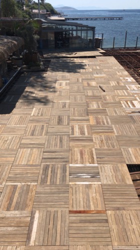 Near complete beach club deck. Repurposed old decking to create new, durable design of deck tiles. Ugur Bolat designed, project managed and oversaw team to install entire deck